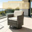 Fauteuil à bascule pivotant rond gris ardoise avec rotin en PE et coussins pour une utilisation à l'extérieur sur la terrasse