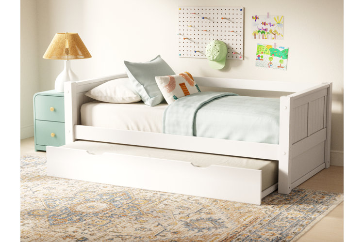 white trundle bed with safari animal–themed bedding
