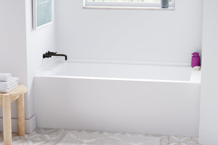 freestanding fiberglass tub in bathroom with a wall-mounted faucet