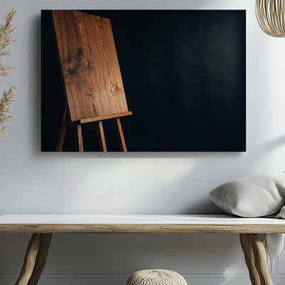 Canvas In A Minimalist Composition A Light Brown Wooden Easel With Wall Art A Pronounced Grain Texture Stands Tall Against A Solid Canvas Wall Art