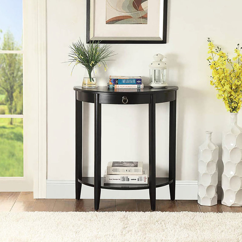 Table basse noire en demi-lune avec tablette inférieure, peu encombrante pour le salon