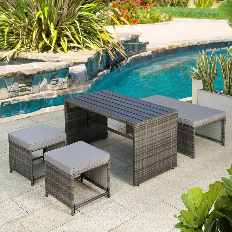 Kiwon 4 - Person Wicker Patio Dining Set with Rectangular Table , Cushions Included