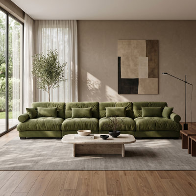 Canapé modulaire 4 places en velours vert, avec pouf amovible, coussins de dossier et traversins.