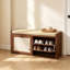 Banc d'entrée robuste avec portes en rotin et siège rembourré pour un rangement organisé des chaussures
