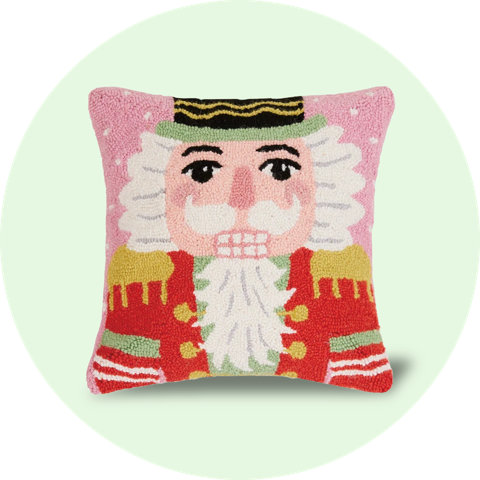 Hooked throw pillow featuring a nutcracker design.