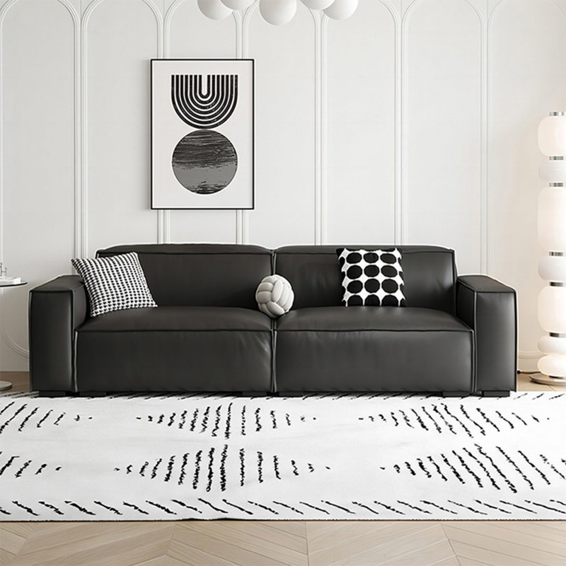 Causeuse-coussin modulable noire en cuir véritable