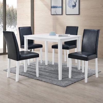 Ensemble de salle à manger rectangulaire moderne 43,3 pouces Boleradice 5 pièces, finition blanche avec chaises rembourrées en similicuir noir, bois d'hévéa massif