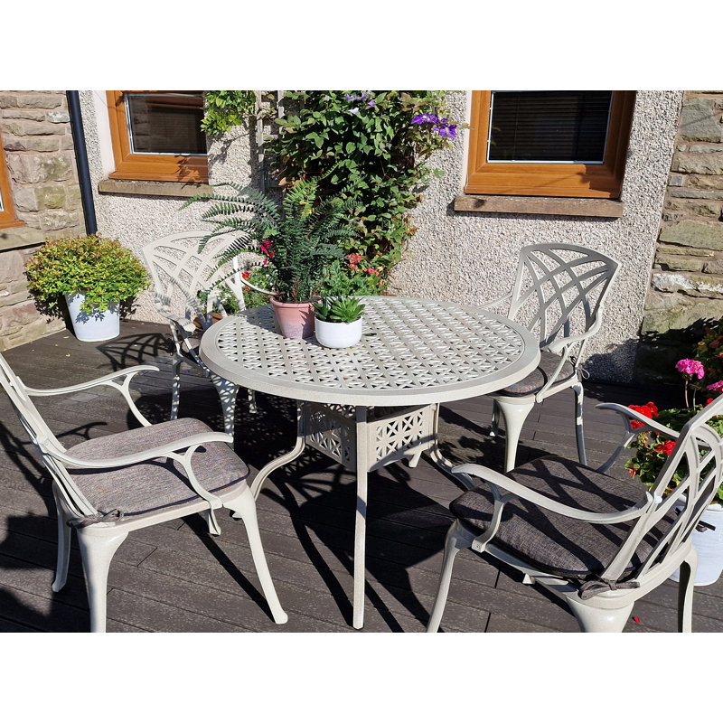 Ryne 4 - Person Patio Dining Set Umbrella Hole Included Round Table with Cushions Included, Sandstone