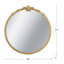 Miroir mural rond avec finition dorée et écusson décoratif
