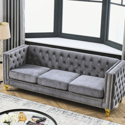 Fauteuil moderne en velours gris à boutons, pieds en métal, espace de travail classique