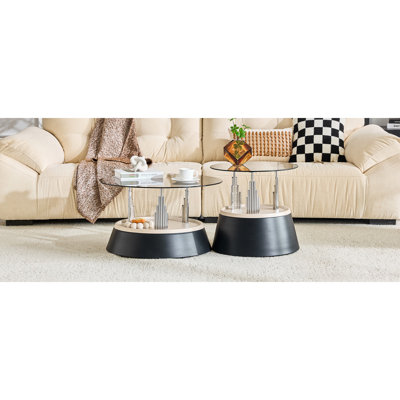 Affordable luxury black nesting coffee table set. Transparent tempered glass nesting set. Round living room coffee table, two-piece set.