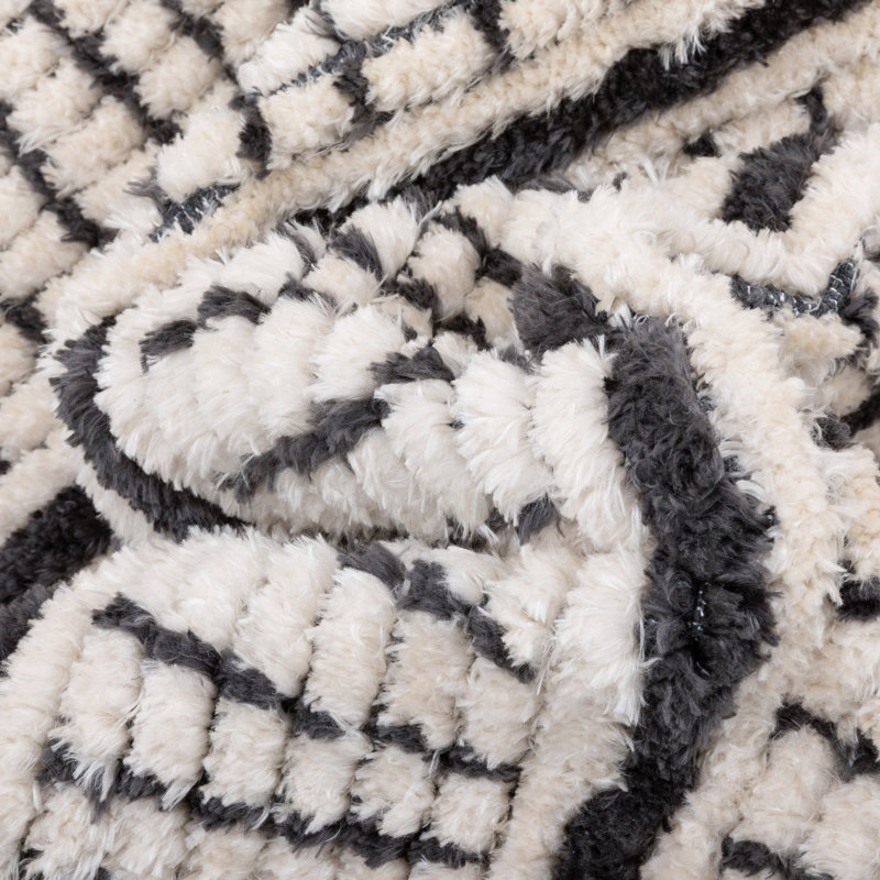 Ivory and Black Geometric Synthetic 4' x 6' Area Rug