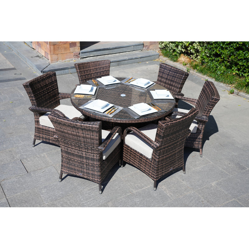 Therasa 6 - Person Patio Dining Set with Round Table , Cushions Included, Brown