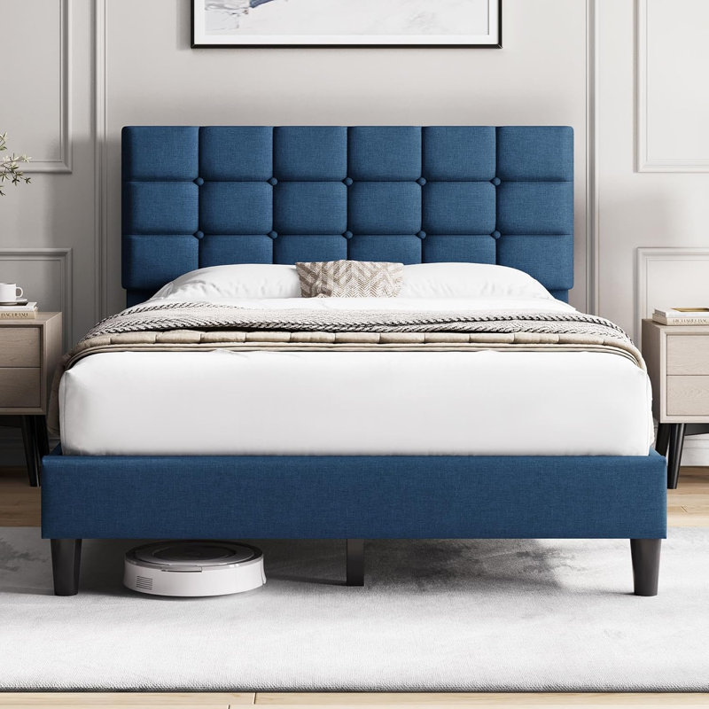 Lit double tapissier bleu avec surpiqures et capitonnage