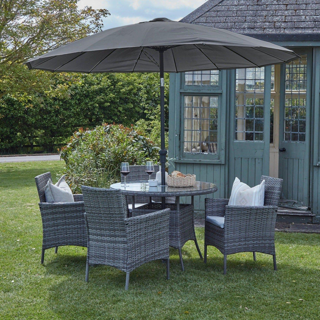 Dubose 4 - Person Wicker Patio Dining Set with Round Table , Cushions Included