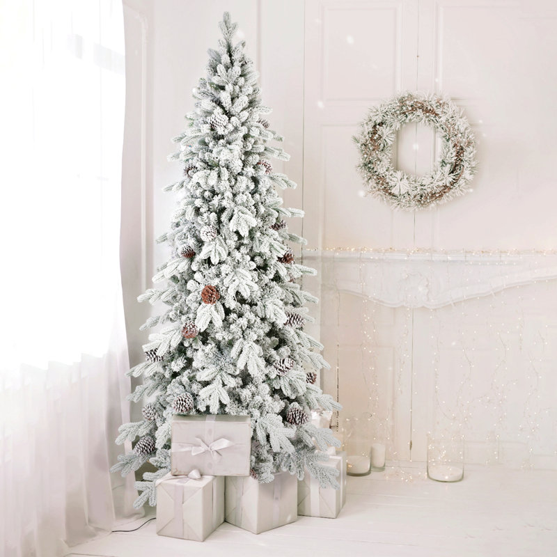 Arbre de Noël floqué en PE / PVC avec pommes de pin naturelles, conception peu encombrante, branches articulées, support en métal stable, aspect enneigé réaliste