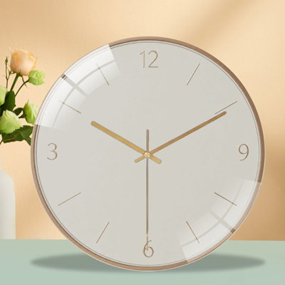 Minimalist wall clock with cream‑white dial, subtle rose‑gold markers and numerals (12, 3, 6, 9), silent‑sweep quartz movement, sleek metal rim. Elegant simple decor ideal for bedroom, living room and office.