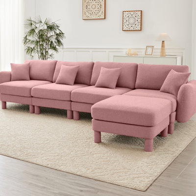Canapé modulaire en L convertible en forme de L à 4 places avec pieds en forme de coquillage, amovibles et cylindriques. Confort et style pour votre espace de bureau