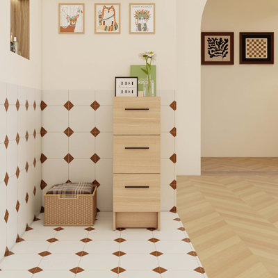 Armoire de rangement de salle de bain autoportante de 12 pouces avec trois tiroirs coulissants et un rangement vertical compact pour les salles de bain compactes.