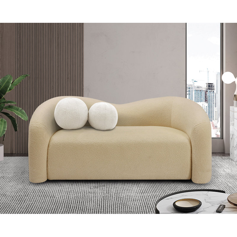 Causeuse rembourrée Kali, Tissu beige en fausse peau de mouton