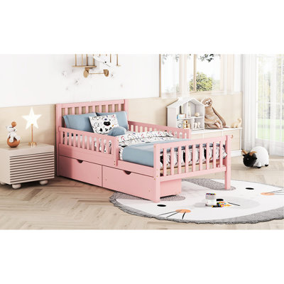 Lit simple en bois de couleur rose avec garde-corps et plateforme de rangement