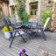 Eleni 4 - Person Patio Dining Set Umbrella Hole Included Round Table