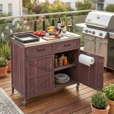 39.4-Inch Dark Brown Outdoor Kitchen Island With Stainless Steel Countertop, Drawers, And Casters For Pizza Making.