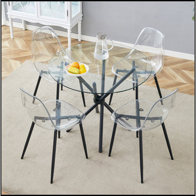 Ensemble de table et de chaises.Une table ronde moderne en verre trempé transparent d'un diamètre de 36,6 pouces, jumelée à 4 chaises de salle à manger en plastique transparent, des pieds en métal noir et un coussin de dossier intégré.
