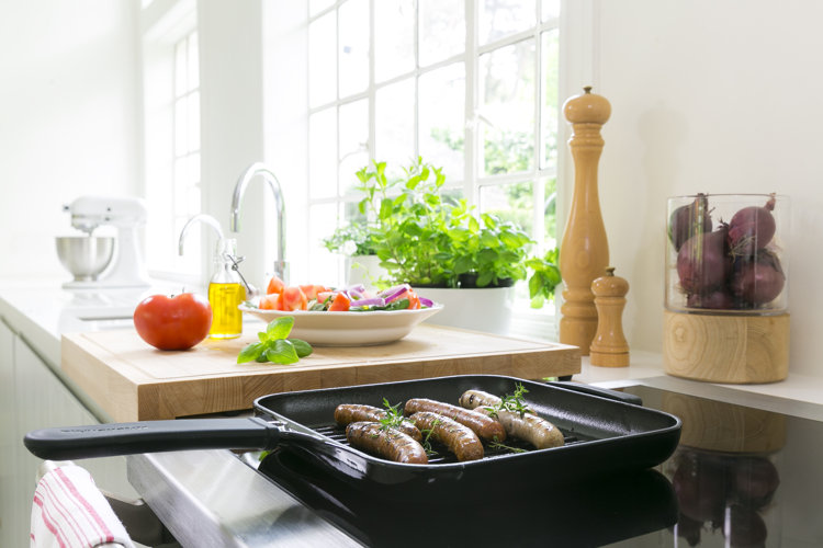 Grill pan in kitchen cooking sausage