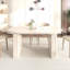 Table de salle à manger extensible pour 4 à 8 personnes, bords arrondis, piètement en lattes de bois, style inspirant, avec coins arrondis, idéale pour les réunions de famille au salon.