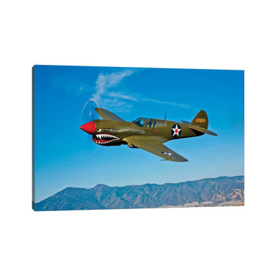 A Curtiss P-40E Warhawk In Flight Near Chino, California II by Scott Germain - Wrapped Canvas Print