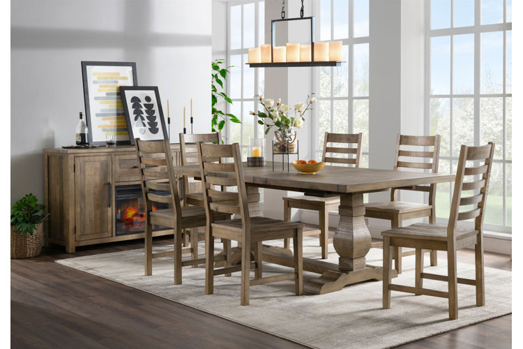 dining room with rustic trestle table, wooden dining chairs, sideboard with modern artwork, and rectangular chandelier