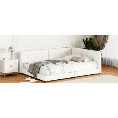 Grand lit tapissier beige avec apparence de cadre et de construction élégante