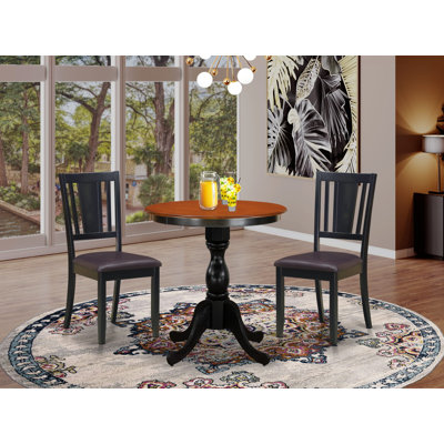 L'ensemble de salle à manger 3 pièces comprend une table de salle à manger ronde avec piédestal et 2 chaises en similicuir, noir et cerise