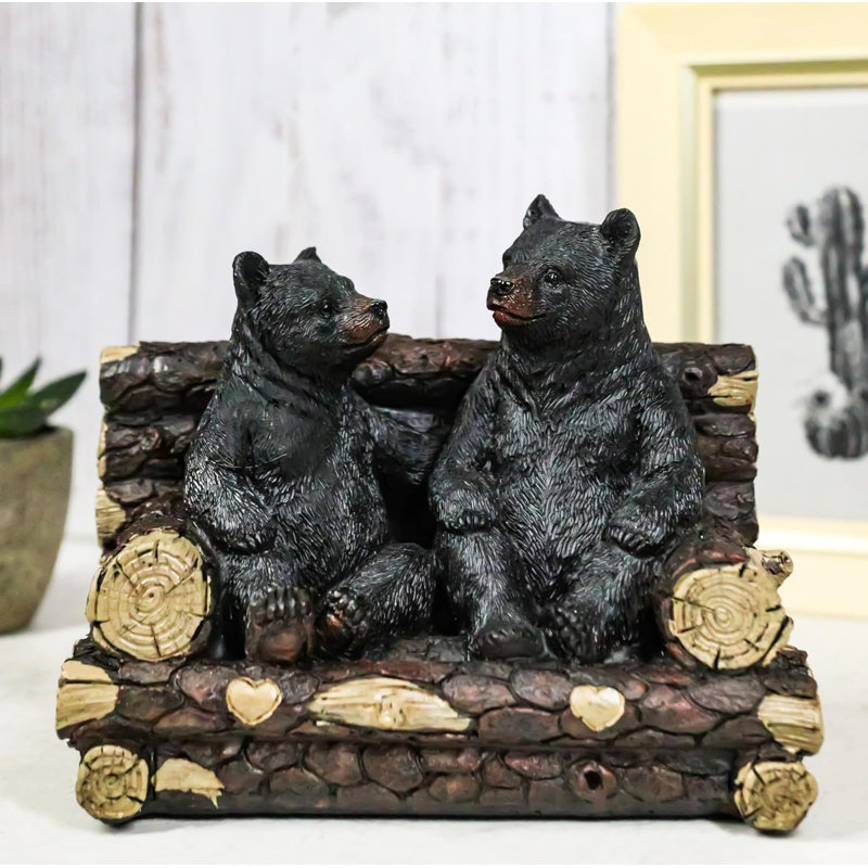 Figurine de père et fils assis sur un arbre