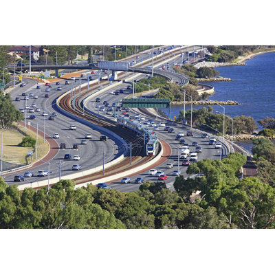 Metro Train Running Down Freeway by Beyondimages