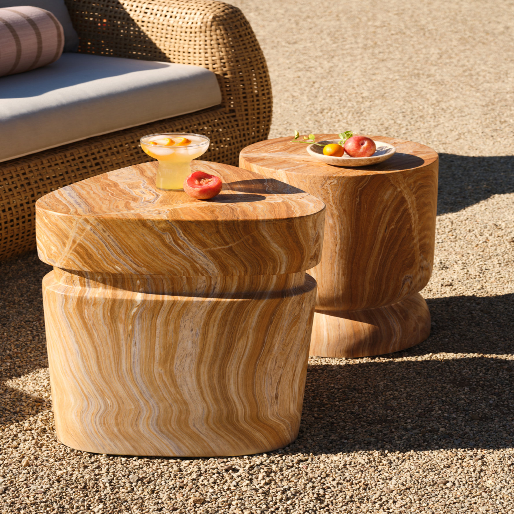 Two outdoor side tables made of light brown wood.