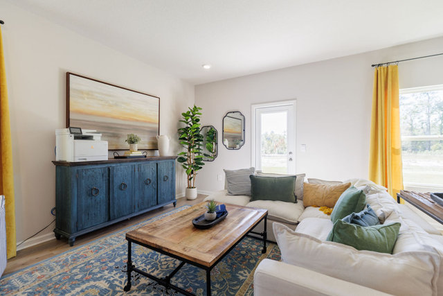 Living room with blue accent cabinet and white sectional sofa.
