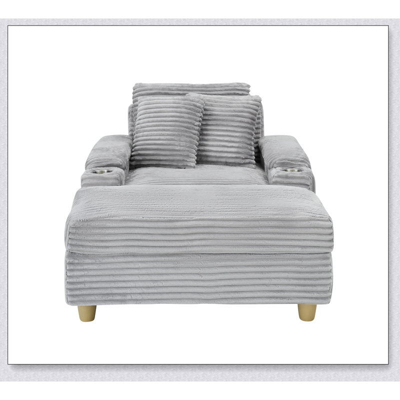 Canapé simple confortable avec coussins, repose-pieds et espaces de rangement, idéal pour se détendre et organiser votre espace de vie