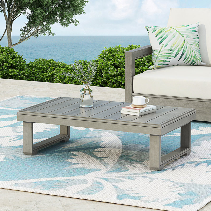 Table basse d'extérieur en bois d'acacia rustique avec plateau à lattes et pieds de traîneau pour un style durable et naturel