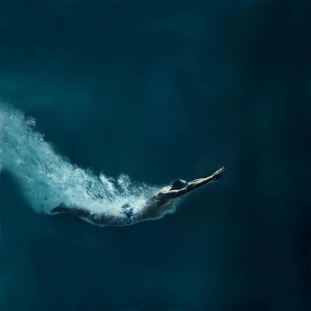 Leinwandbild Swimmer Diving After The Jump, Underwater View