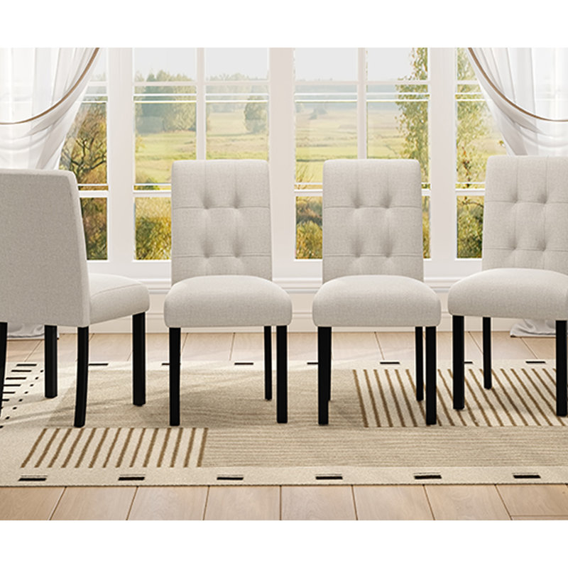 Ensemble de chaises de salle à manger capitonnées 4 pièces avec revêtement en lin et pieds en bois d'hévéa robustes pour une utilisation polyvalente à la maison.