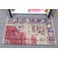 Tapis de porte traditionnel turc dans des tons de rouge et de crème avec des motifs floraux ornés, idéal pour la décoration intérieure