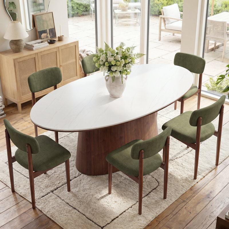 Ensemble de salle à manger Hayes de style milieu du siècle, comprenant une table ovale en pierre blanche frittée, 6 chaises de salle à manger rembourrées et un pied central en bois massif. Ensemble de cuisine 7 pièces.
