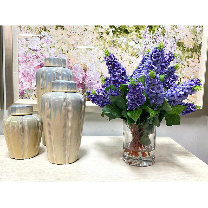 Italian Lilac Floral Arrangement In A Cylindrical Glass Vase