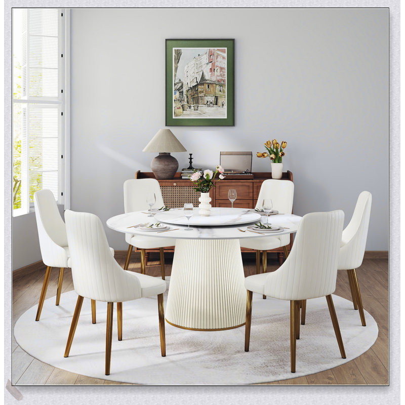 Table de salle à manger ronde moderne en pierre artificielle blanche avec plateau tournant et six chaises, idéale pour les réunions élégantes et les repas de famille