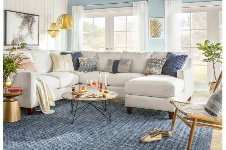 coastal living room with blue throw pillows and blue rug