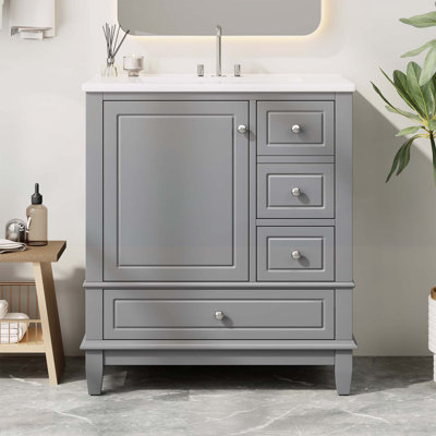 Meuble-lavabo de salle de bain avec lavabo, une porte avec tablette et trois tiroirs
