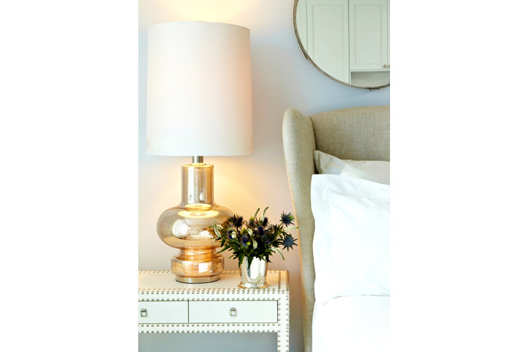 nightstand with gold lamp