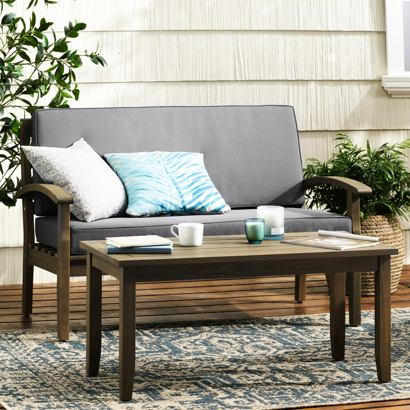 Mobilier de jardin : Table basse en bois gris foncé, largeur 82,5 cm, coussins d’eau inclus